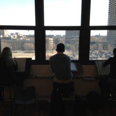 student drawing near a window